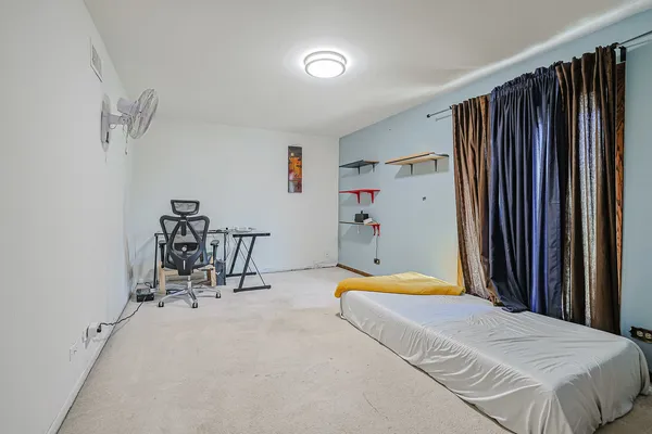 a bedroom with a bed and a table in it