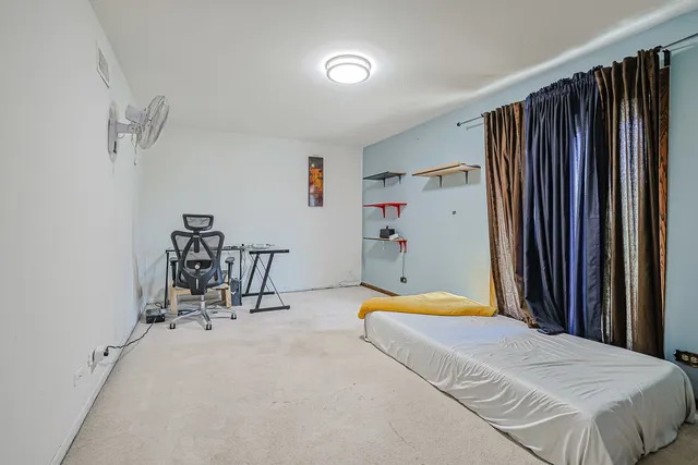 a bedroom with a bed and a table in it