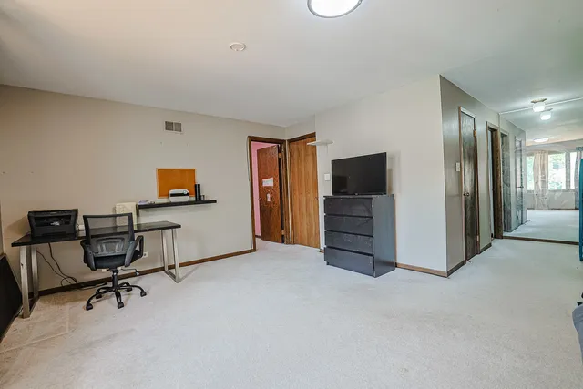 a view of a livingroom with furniture and a flat screen tv