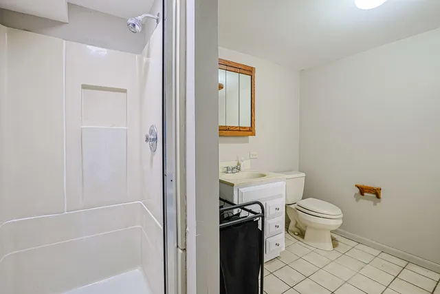a bathroom with a toilet and a shower