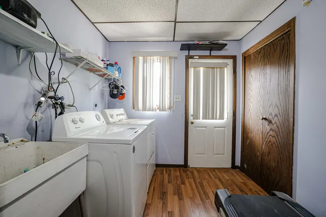 a bathroom with a sink and mirror with bathtub