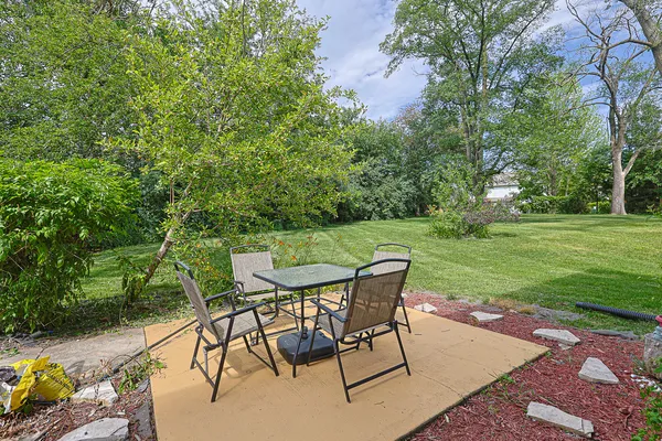 a view of a backyard with a sitting area