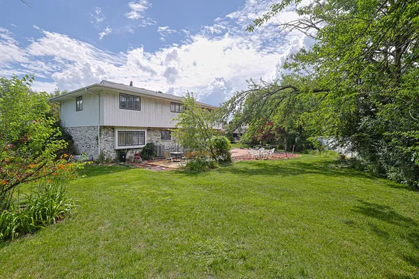 a front view of a house with plants and garden