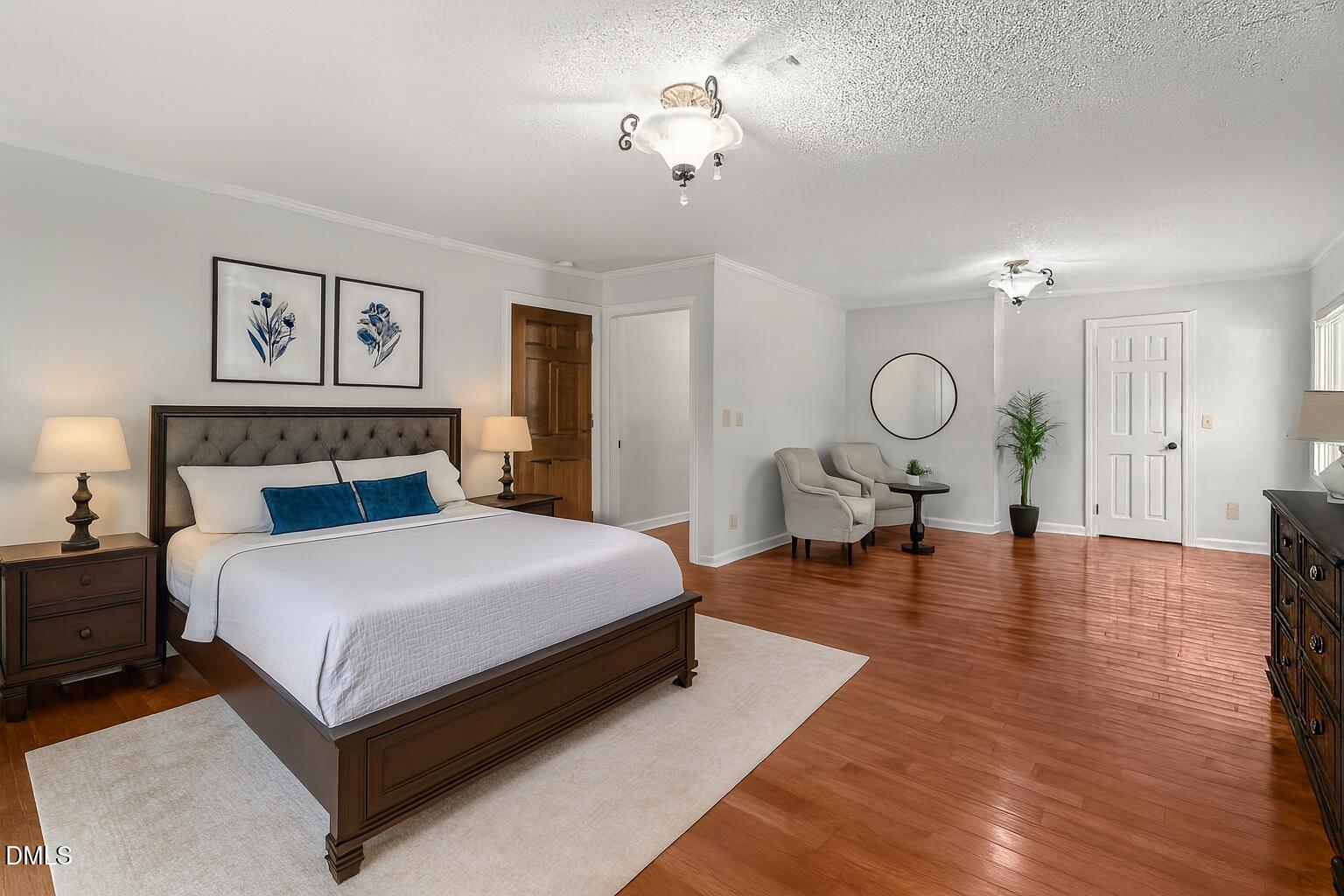 919 Drag Strip Road Benson, NC 27504 - Photo 19 of 54 a spacious bedroom with a bed and cabinets