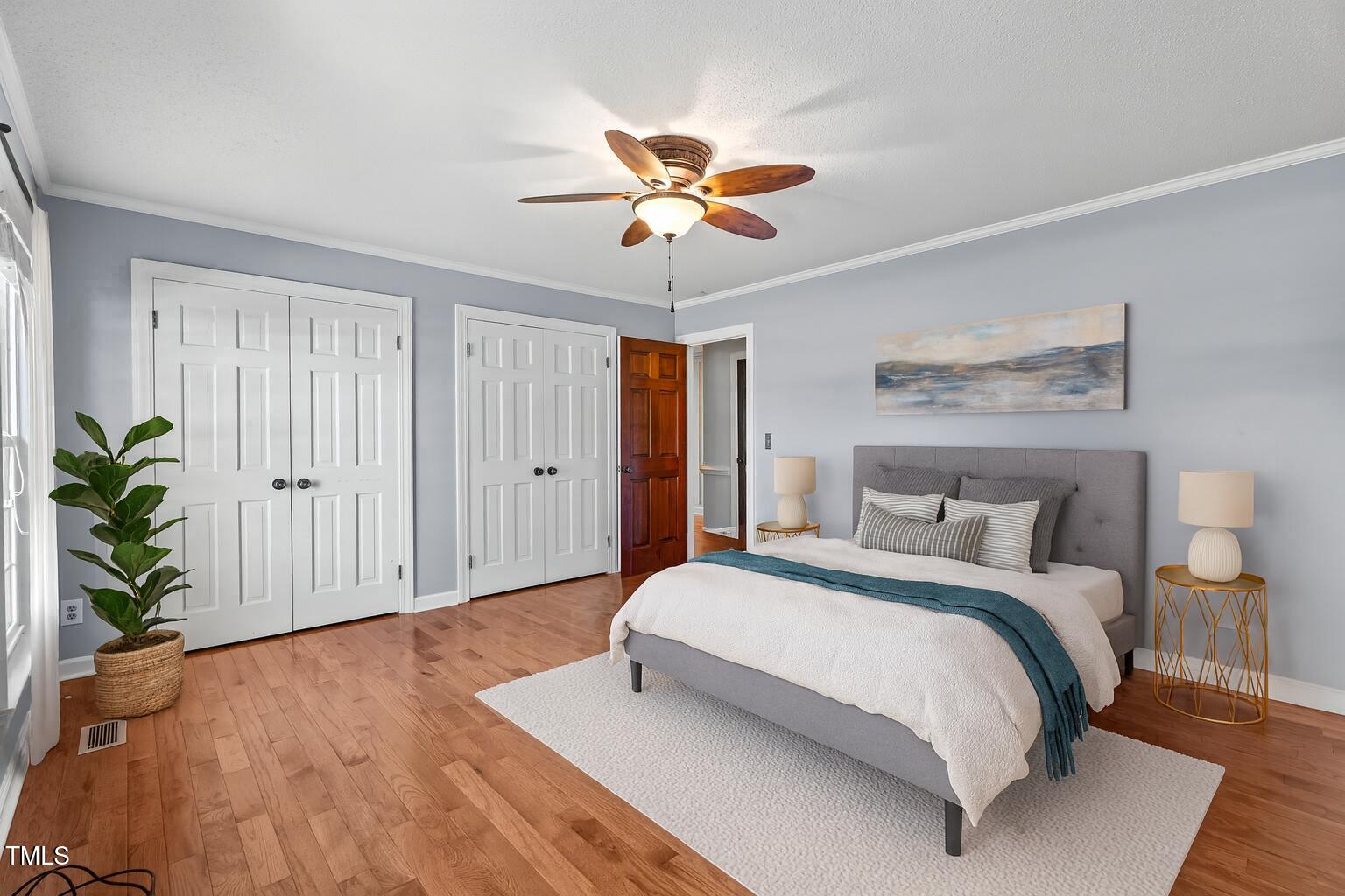 919 Drag Strip Road Benson, NC 27504 - Photo 22 of 54 a bedroom with a bed and a chandelier
