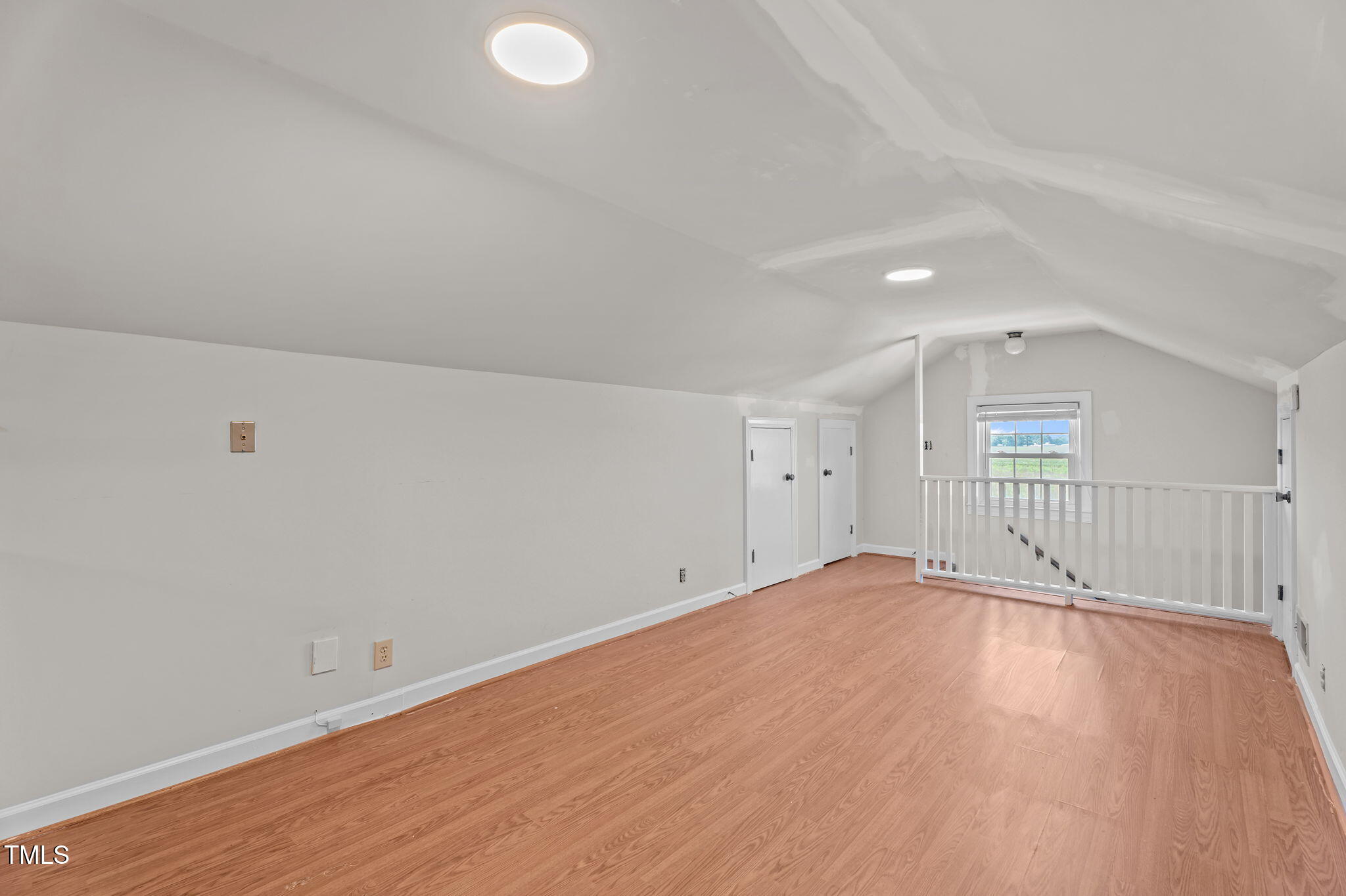 919 Drag Strip Road Benson, NC 27504 - Photo 36 of 54 an empty room with wooden floor and windows