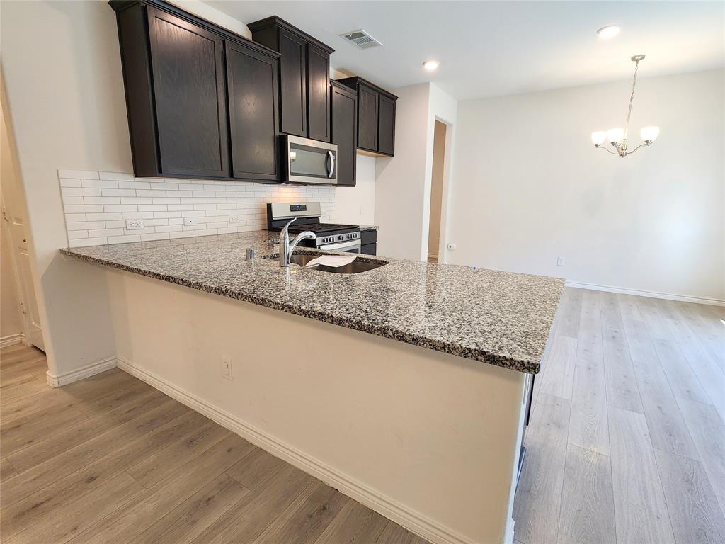 2124 Hobby Drive Forney, TX 75126 - Photo 12 of 40 Breakfast bar viewed from living room