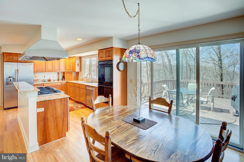 17991 Raven Rocks Road Bluemont, VA 20135 - Photo 13 of 30 a kitchen with stainless steel appliances granite countertop a stove and refrigerator