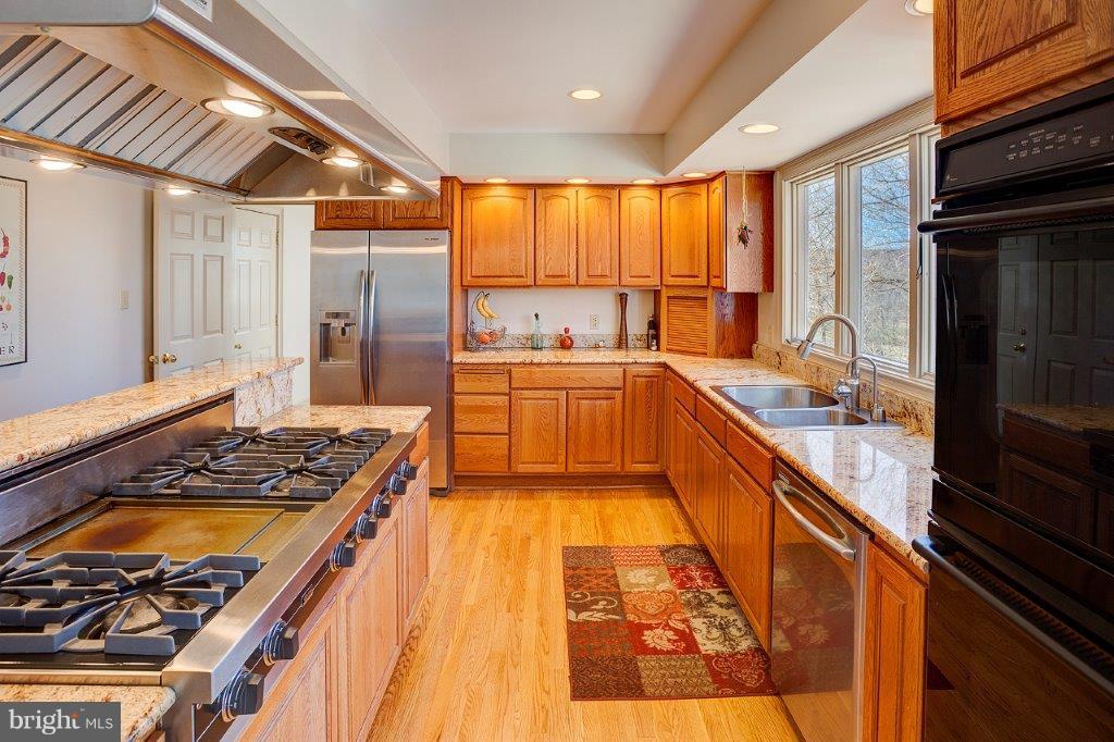 17991 Raven Rocks Road Bluemont, VA 20135 - Photo 16 of 30 a large kitchen with stainless steel appliances granite countertop a large stove a sink and dishwasher
