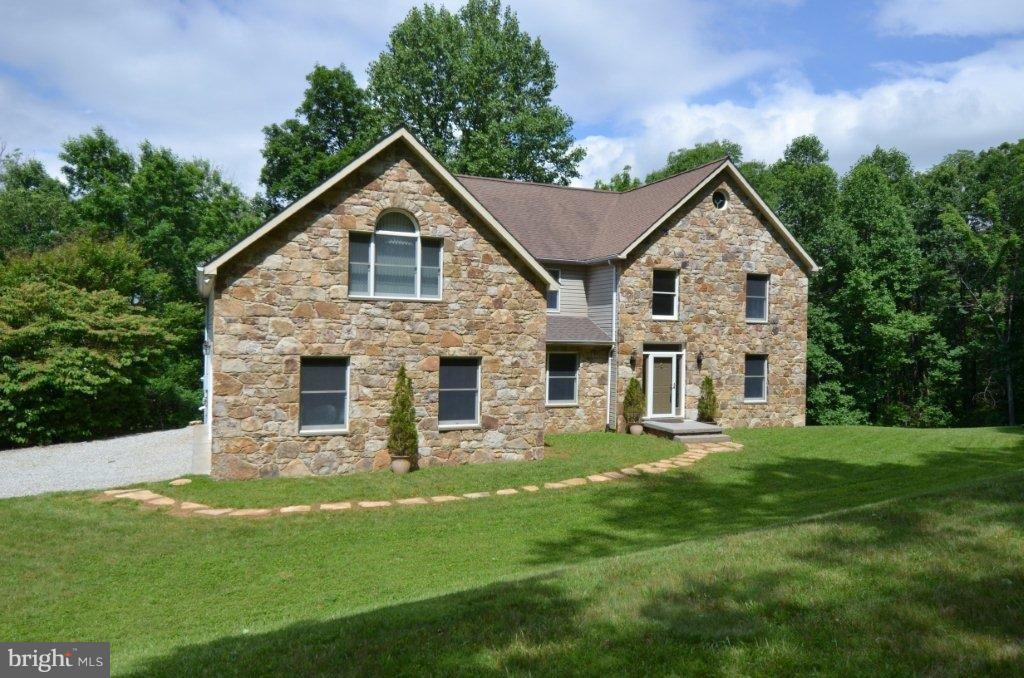 17991 Raven Rocks Road Bluemont, VA 20135 - Photo 3 of 30 a front view of a house with a yard and trees