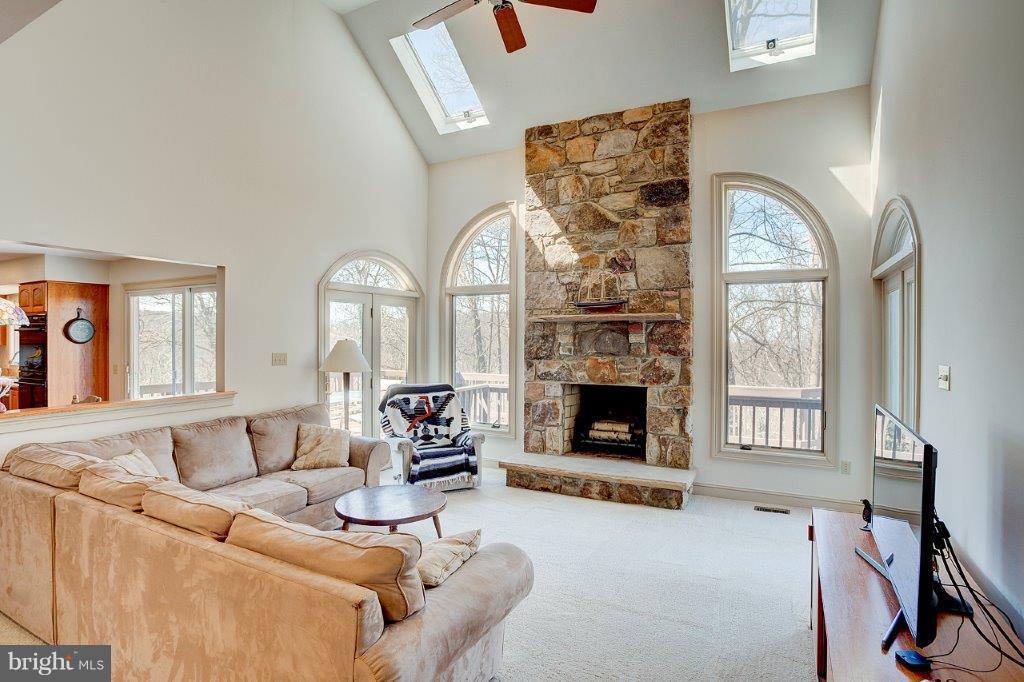 17991 Raven Rocks Road Bluemont, VA 20135 - Photo 8 of 30 a living room with furniture a large window and a fireplace