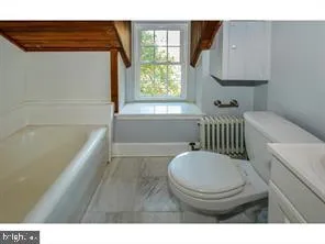 a bathroom with a toilet a sink and bathtub