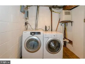 a view of a bedroom with washer and dryer