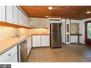 a kitchen with a refrigerator and cabinets