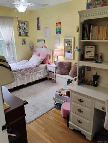 a bedroom with furniture and a wooden floor