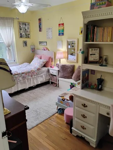 a bedroom with furniture and a wooden floor