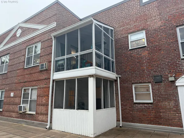 a view of a brick building with large windows