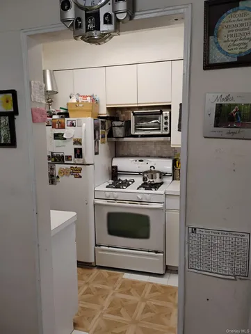 a kitchen with stainless steel appliances a stove a microwave and a refrigerator