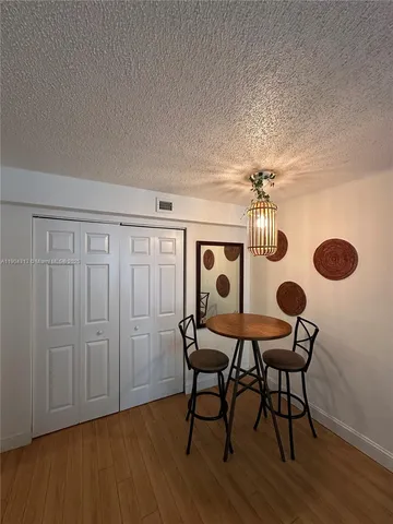 a dining room with furniture and wooden floor