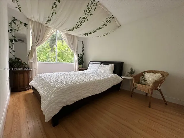 a bedroom with a bed chair and window