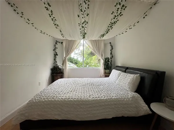 a bedroom with a bed and a window
