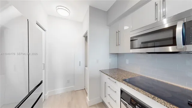 a kitchen with a stove and a microwave