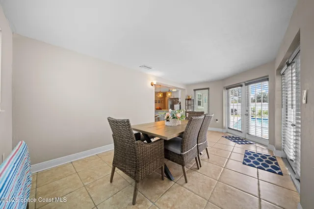 a work room with furniture and large windows
