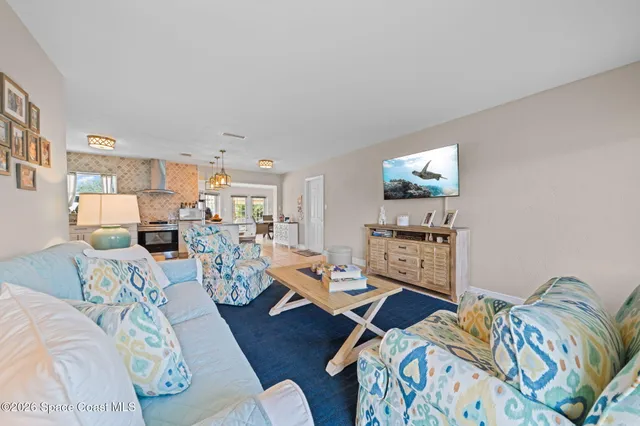a living room with furniture a dining table and a clock