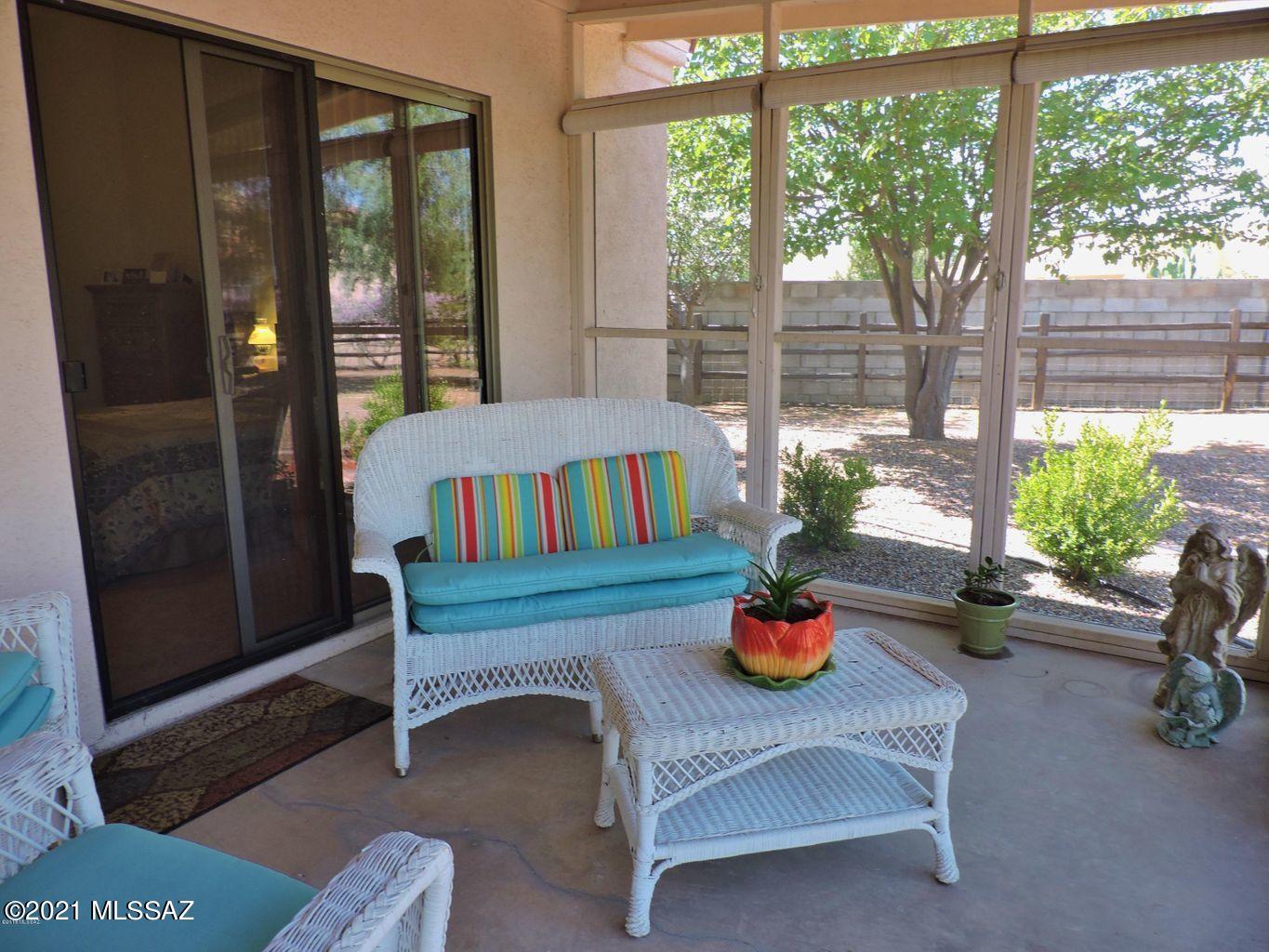 1704 Leary Court Rio Rico, AZ 85648 - Photo 30 of 37 a bedroom with a bed a large window and potted plants