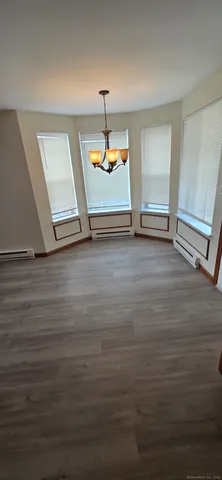 a view of room with window and wooden floor