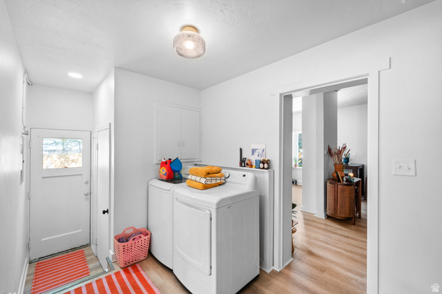 257 200 South Provo, UT 84606 - Photo 14 of 40 Laundry room with separate washer and dryer, light wood-type flooring, cabinet space, and a textured ceiling