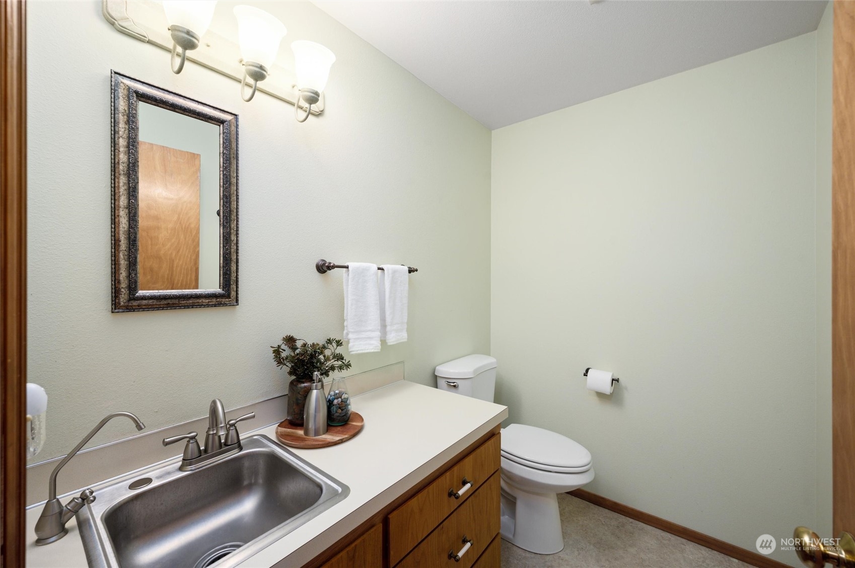 6002 Aldrich Road Bellingham, WA 98226 - Photo 17 of 30 a bathroom with a sink a toilet and mirror