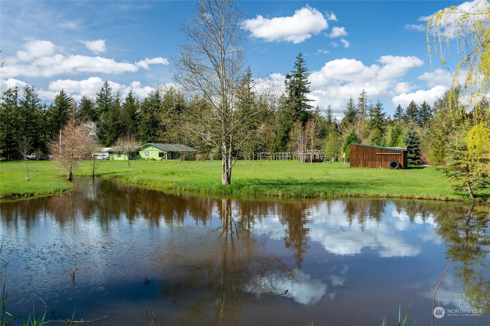 6002 Aldrich Road Bellingham, WA 98226 - Photo 24 of 30 a view of a lake with a house in the background