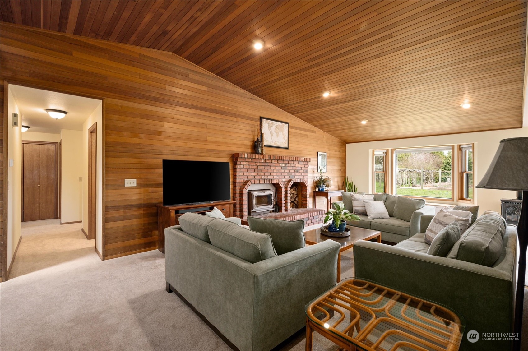 6002 Aldrich Road Bellingham, WA 98226 - Photo 3 of 30 a living room with furniture a flat screen tv and a fireplace
