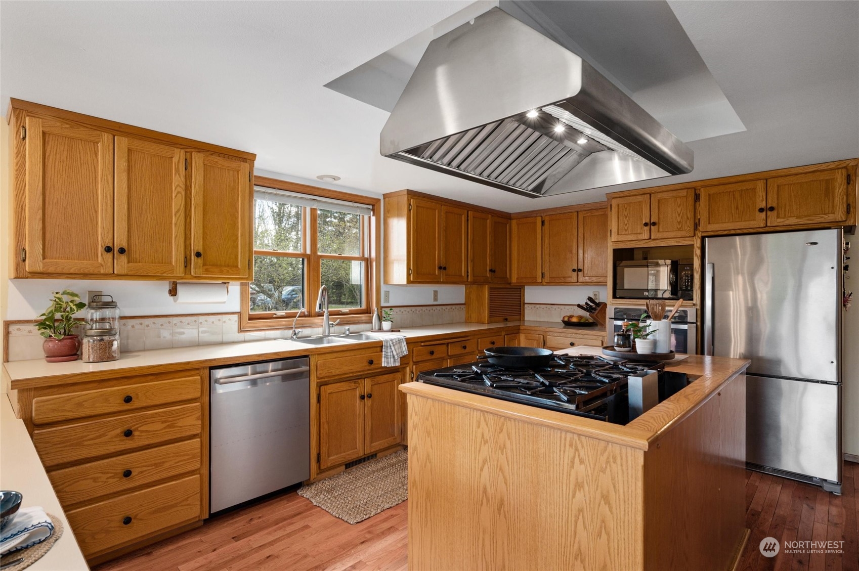 6002 Aldrich Road Bellingham, WA 98226 - Photo 8 of 30 a kitchen with stainless steel appliances granite countertop a stove a sink dishwasher and a refrigerator