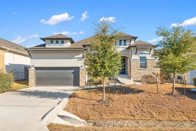 a view of an empty room with wooden floor and window