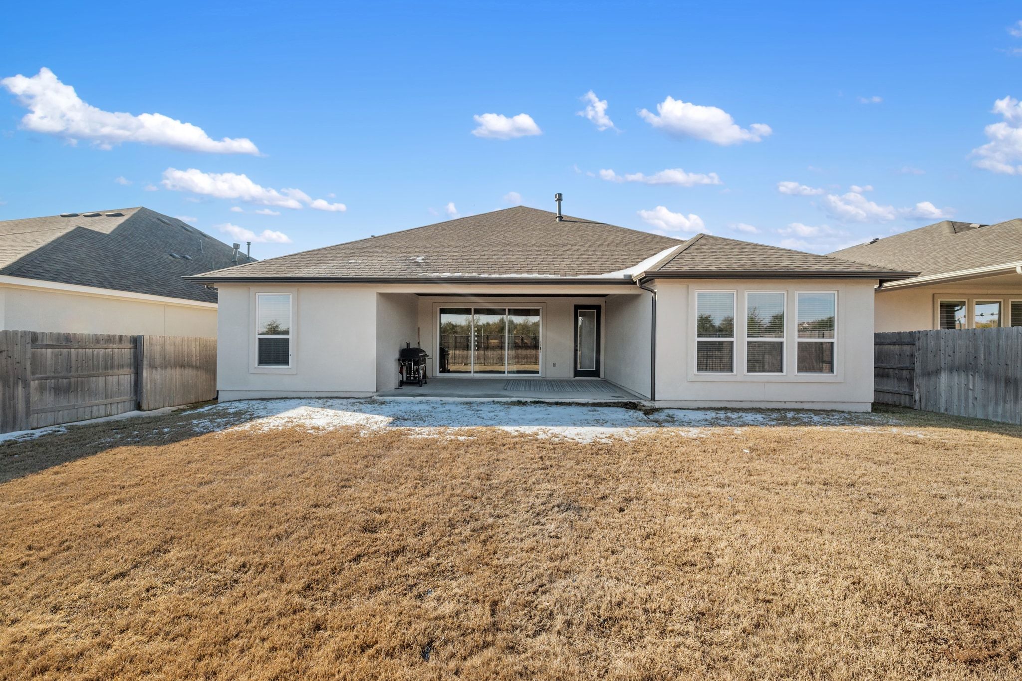 957 Arrowhead Ranch Boulevard Dripping Springs, TX 78620 - Photo 23 of 31 Rear view of property featuring a fenced backyard, stucco siding, a patio area, and roof with shingles