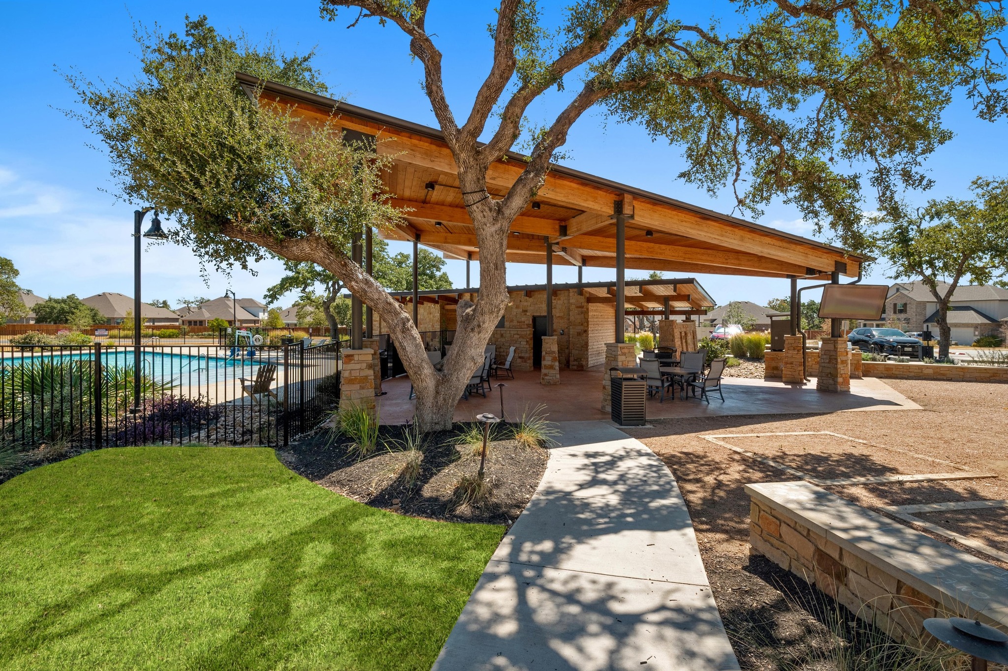 957 Arrowhead Ranch Boulevard Dripping Springs, TX 78620 - Photo 27 of 31 Surrounding community featuring a patio, a swimming pool, a residential view, and outdoor dining space