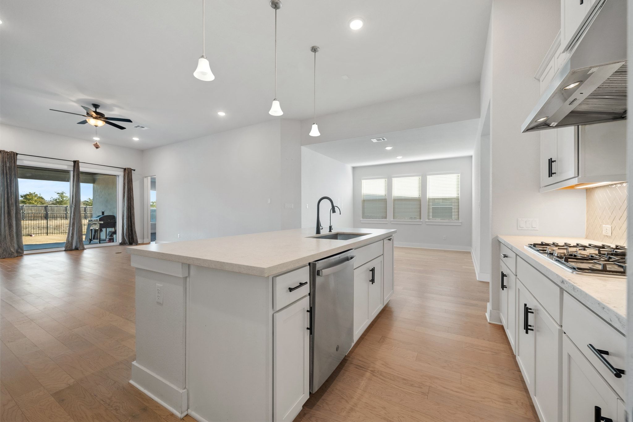 957 Arrowhead Ranch Boulevard Dripping Springs, TX 78620 - Photo 31 of 31 Kitchen featuring open floor plan, white cabinetry, an island with sink, pendant lighting, and recessed lighting