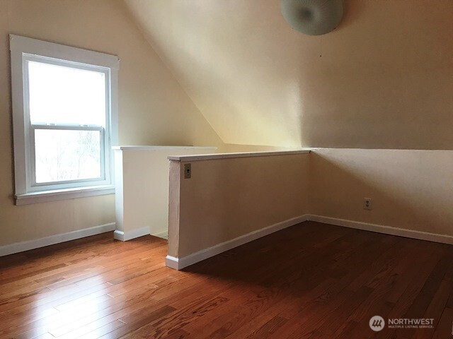 1920 East Jefferson Street, Unit B Seattle, WA 98122 - Photo 4 of 9 an empty room with wooden floor and windows