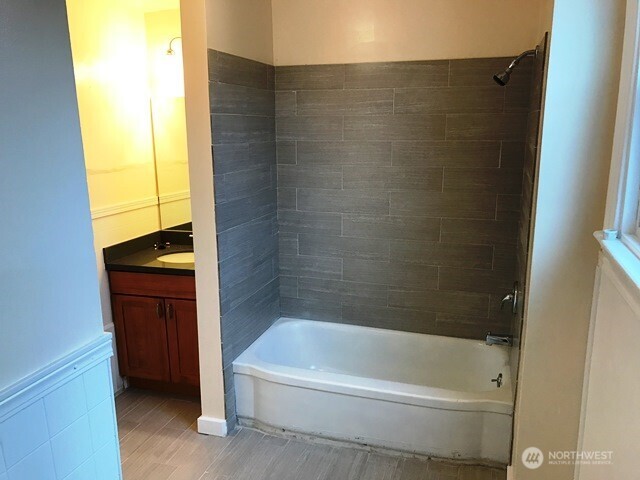 1920 East Jefferson Street, Unit B Seattle, WA 98122 - Photo 6 of 9 a bathroom with a bathtub and a shower