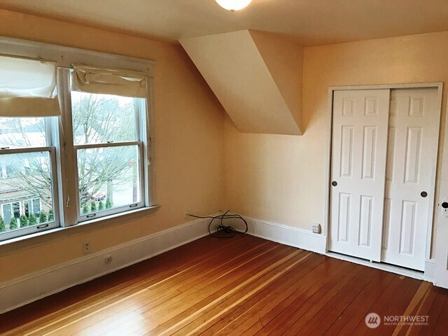 1920 East Jefferson Street, Unit B Seattle, WA 98122 - Photo 7 of 9 a view of a room with wooden floor and windows