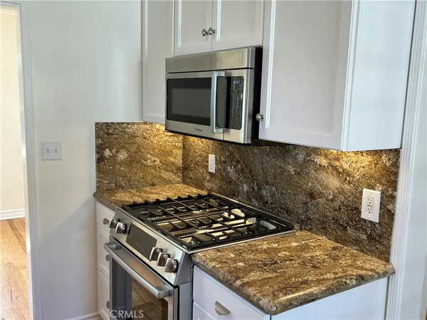 a kitchen with a stove and a microwave