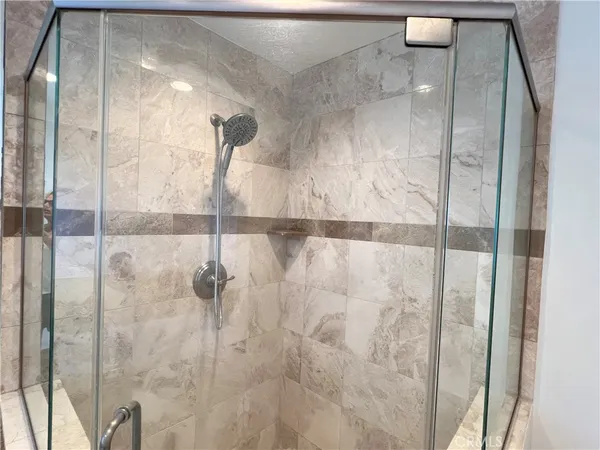 a bathroom with a glass shower door