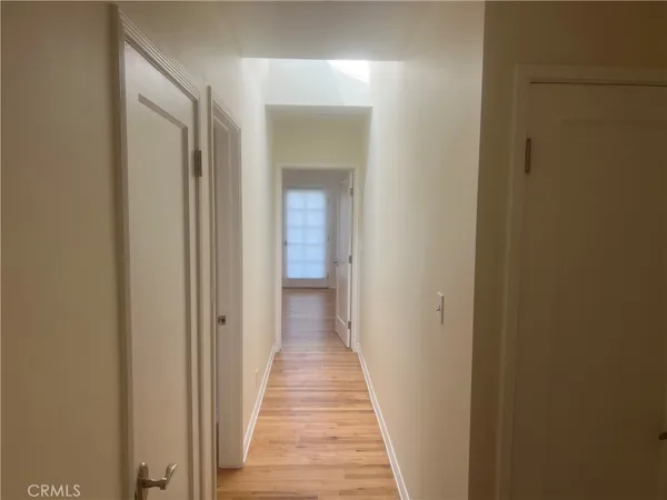 a view of a hallway with wooden floor