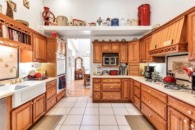 a kitchen with stainless steel appliances a sink dishwasher stove and cabinets