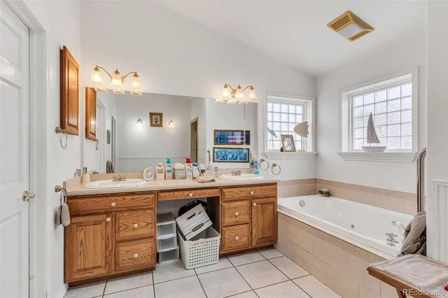 a spacious bathroom with a granite countertop tub sink and mirror