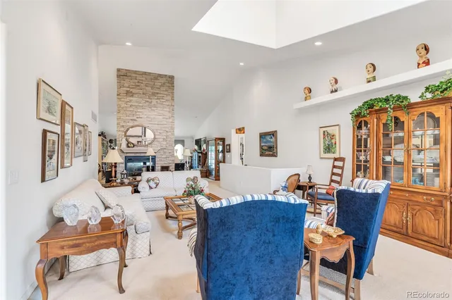 a living room with fireplace furniture and a wooden floor