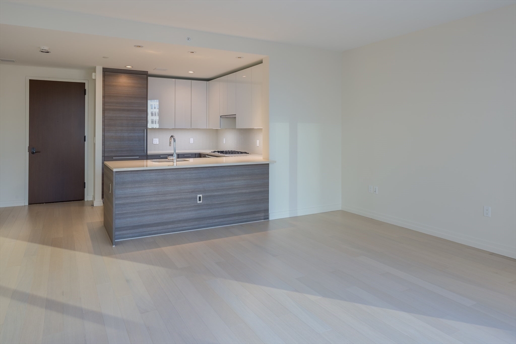 1 Franklin Street, Unit 1709 Boston, MA 02110 - Photo 2 of 17 a view of kitchen with granite countertop cabinets and sink