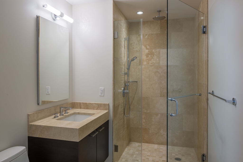 1 Franklin Street, Unit 1709 Boston, MA 02110 - Photo 5 of 17 a bathroom with a sink a toilet and shower
